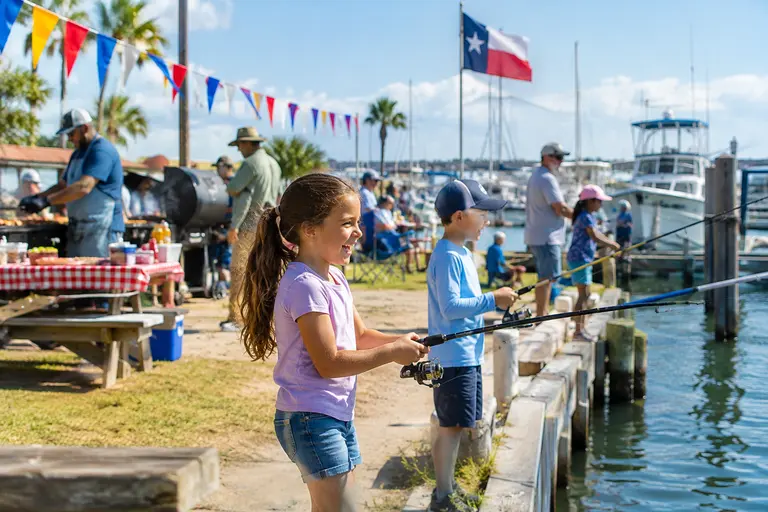 Fishing boats gathered near a Texas coastal launch before a redfish event